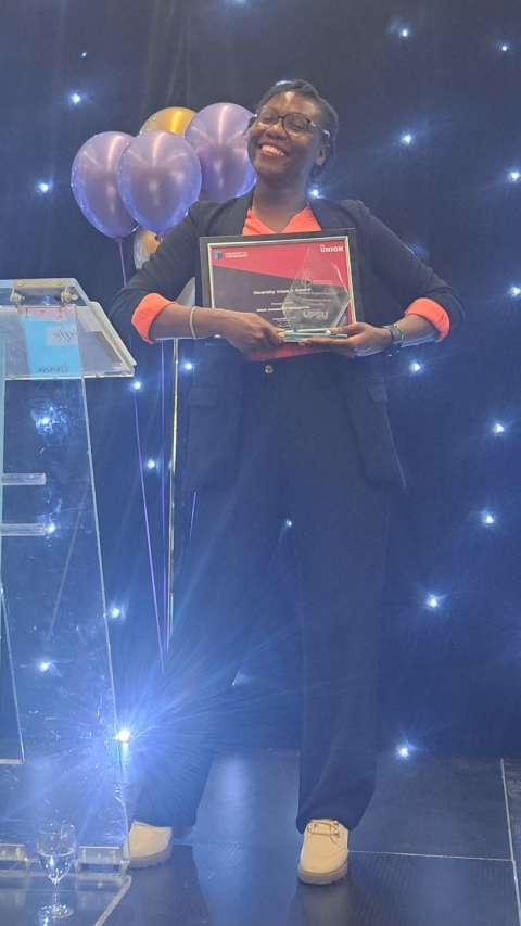 Ritah Namaganda holding her award