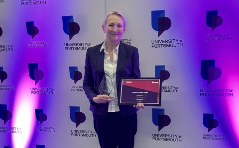 Helen Fleming holding her award