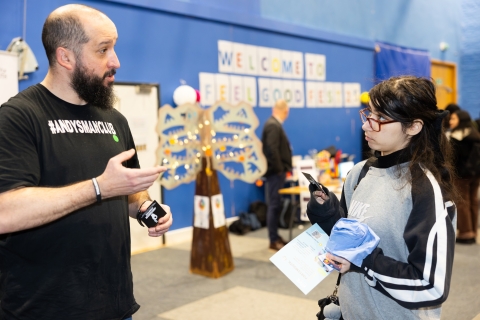 Man and woman having a conversation at a Andys Man Club exhibition stall