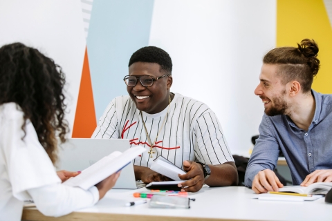 Students studying together in a group smiling and enjoying themselves