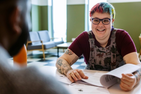student with glasses and brightly coloured hair