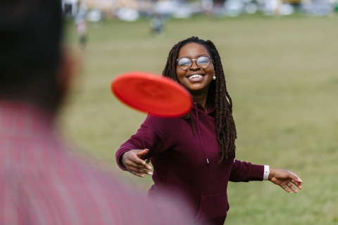 Student playing frisbee on the Common