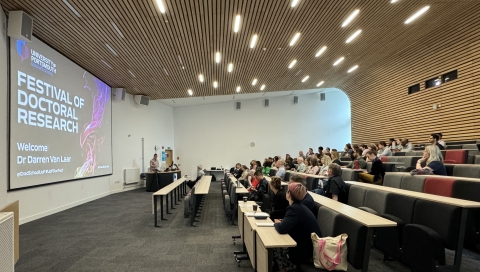 People listening to a talk in the Eldon building large tiered lecture theatre