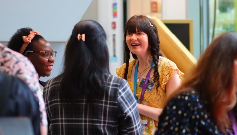 Three PGR students standing and talking at the festival