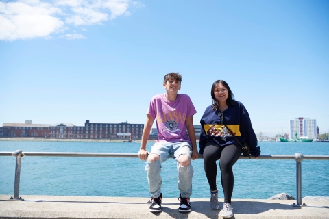 Two students sitting on the railing overlooking Gosport