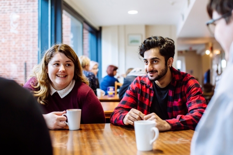Male and female University of Portsmouth students drinking coffee