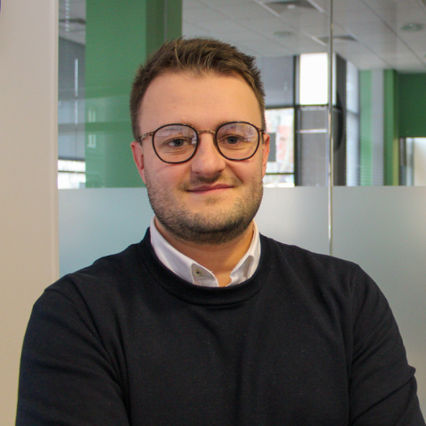 Picture of a young man with light hair and glasses, standing in the Careers and Employability Centre