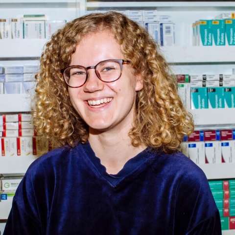 Smiling female student in pharmacy