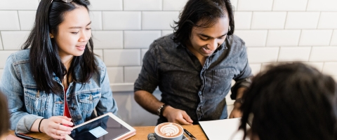 group of students in coffee shop working