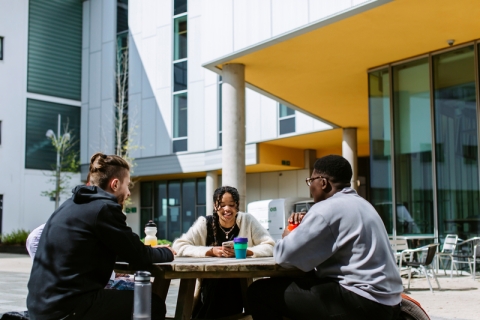 Students sitting having coffee outdoors