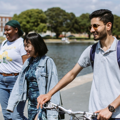Three students walking by Canoe Lake in Southsea