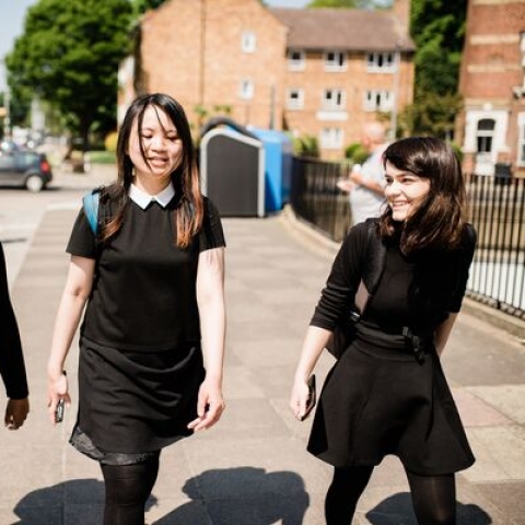 international students walking on sunny street and talking