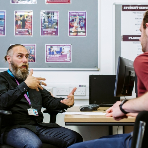 Two people sitting and talking
