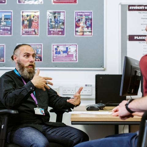 Two people sitting and talking