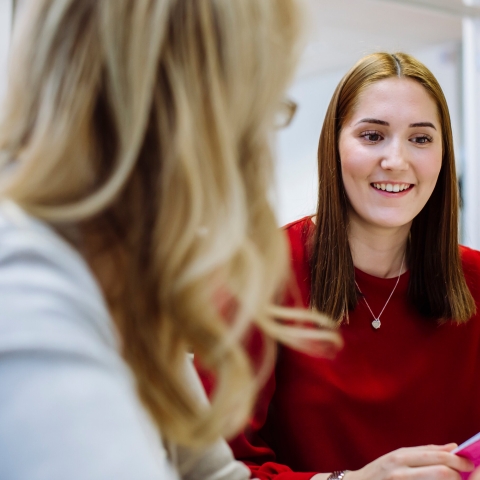 A student smiling in a meeting with her personal tutor