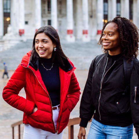 two female students walking and talking together