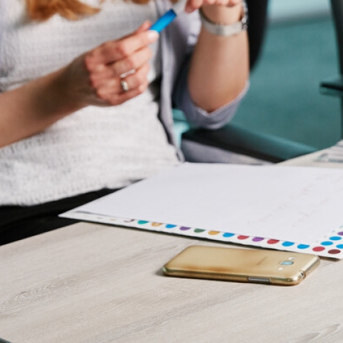 Two people meeting with a laptop and paper pads