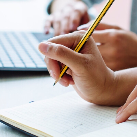Postgrad students taking notes and planning essay