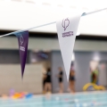 Purple and white bunting with the University of Portsmouth's logo on the flags