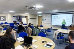 Students attending a session in a University training room