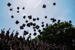 Graduates throwing caps in the air