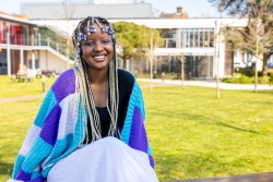 Botswanan student Koke smiling outside a University building 