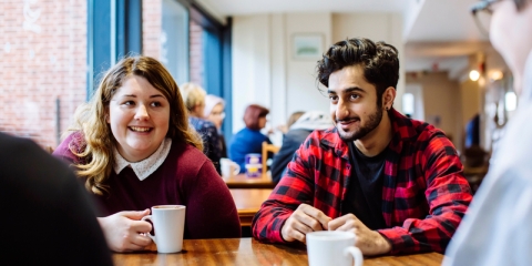 Male and female University of Portsmouth students drinking coffee