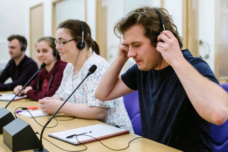 Male translator in speaking into microphone