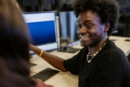 Students talking whilst sat at computer desksTechnology Facilities Day One