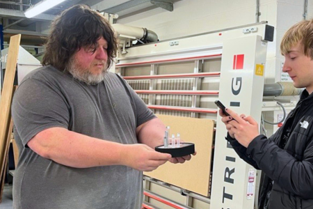 Steve Oliver, Senior Specialist Technician, holding the Student Impact Award prototype