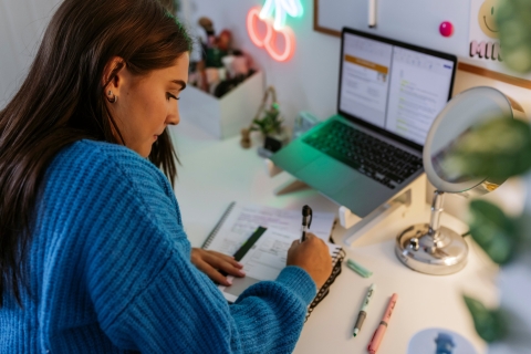 Student writing notes