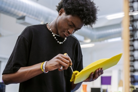 Student using screwdriver on yellow plastic component.
Technology Facilities Day One