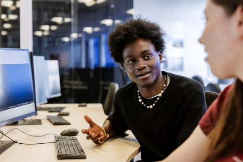Students talking whilst sat at computer desksTechnology Facilities Day One - NOT FOR THIRD PARTY - CONSENT