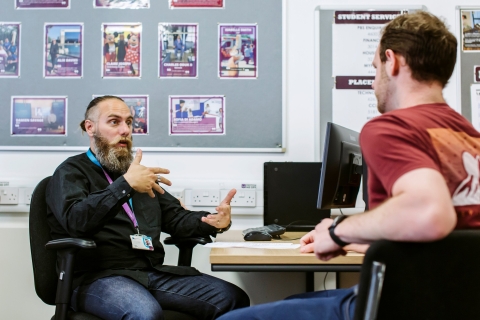 Staff discussing issues with a student