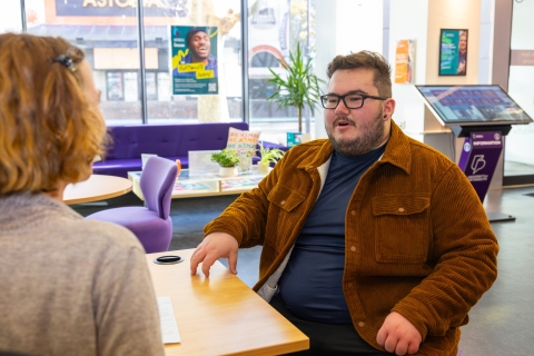 Two people sitting and talking