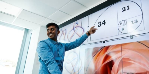 Student pointing at smart board