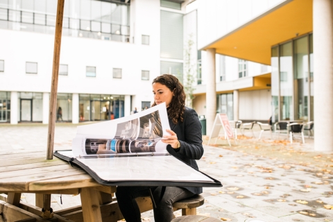 Female student looking over project in Eldon Courtyard